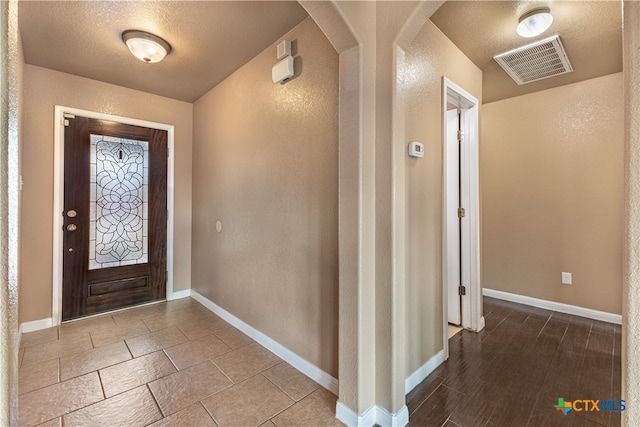 entrance foyer with a textured ceiling