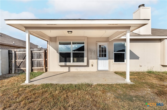 back of house featuring a yard and a patio area