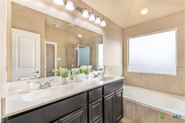 bathroom featuring vanity, plus walk in shower, and vaulted ceiling