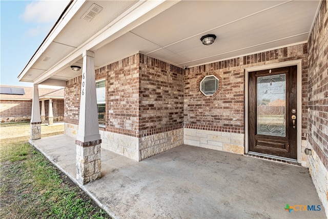 doorway to property featuring a patio area