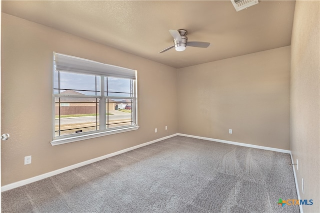 spare room featuring carpet flooring and ceiling fan