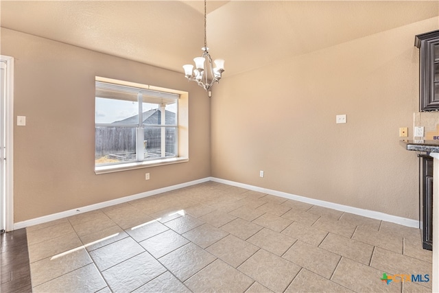 unfurnished dining area featuring a notable chandelier