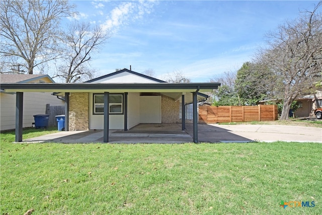 back of property featuring a patio and a yard