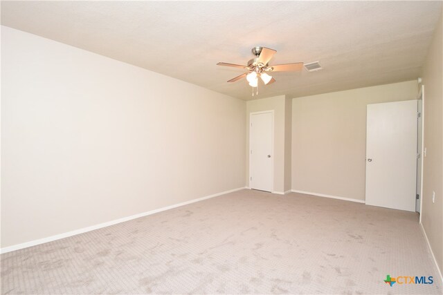 spare room with light carpet and ceiling fan