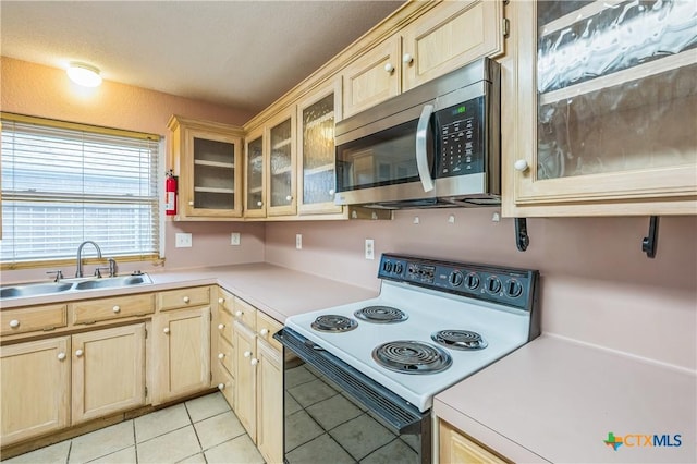4803 Chad Dr, Killeen, TX 76542 - kitchen with light brown cabinetry, a sink, light countertops, electric stove, and stainless steel microwave