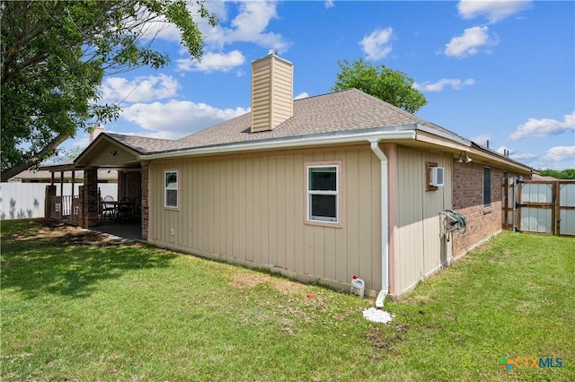4803 Chad Dr, Killeen, TX 76542 - rear view of property featuring roof with shingles, fence, a yard, and a chimney
