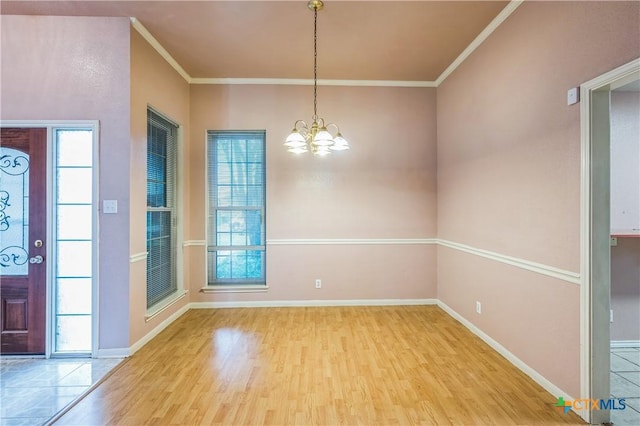 4803 Chad Dr, Killeen, TX 76542 - unfurnished dining area featuring crown molding, baseboards, wood finished floors, and a notable chandelier