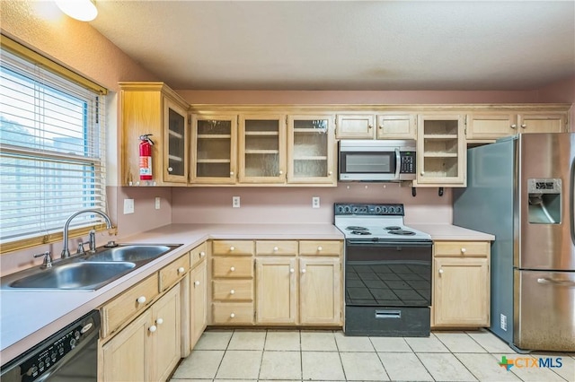 4803 Chad Dr, Killeen, TX 76542 - kitchen featuring light countertops, a sink, light tile patterned flooring, and stainless steel appliances
