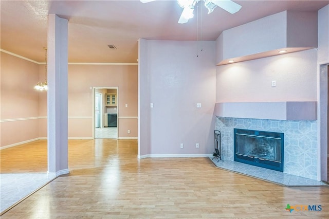 4803 Chad Dr, Killeen, TX 76542 - unfurnished living room with a tiled fireplace, baseboards, ceiling fan, and wood finished floors