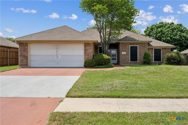 4803 Chad Dr, Killeen, TX 76542 - single story home featuring fence, a front yard, brick siding, an attached garage, and driveway