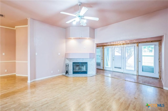 4803 Chad Dr, Killeen, TX 76542 - unfurnished living room featuring baseboards, ceiling fan, a fireplace with flush hearth, and light wood-style flooring