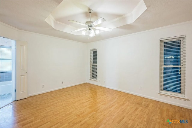 4803 Chad Dr, Killeen, TX 76542 - unfurnished room featuring ceiling fan, wood finished floors, baseboards, ornamental molding, and a tray ceiling