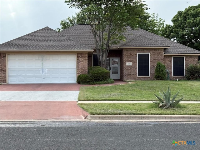 4803 Chad Dr, Killeen, TX 76542 - ranch-style house with brick siding, a garage, roof with shingles, and a front lawn