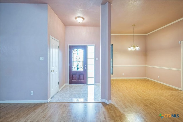 4803 Chad Dr, Killeen, TX 76542 - entryway featuring baseboards, wood finished floors, and a notable chandelier