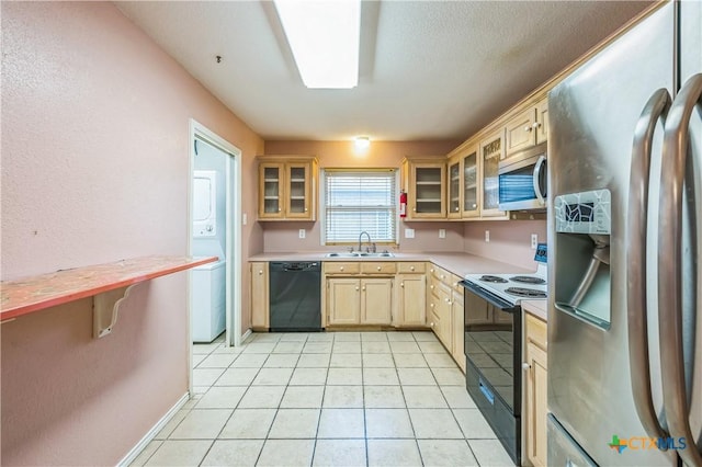 4803 Chad Dr, Killeen, TX 76542 - kitchen featuring light brown cabinets, glass insert cabinets, light countertops, a sink, and appliances with stainless steel finishes