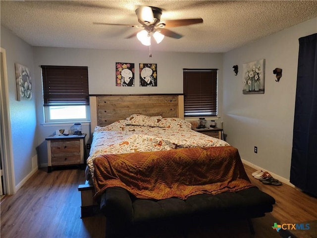 1309 Hawk Trl, Copperas Cove, TX 76522 - bedroom featuring wood finished floors, baseboards, a ceiling fan, and a textured ceiling