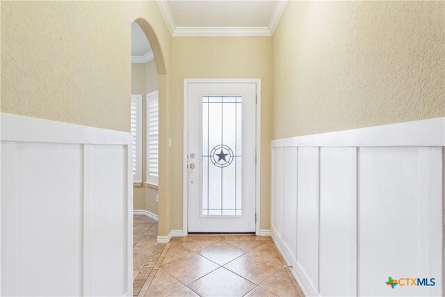 127 Ariana Ct, Killeen, TX 76542 - entryway featuring a textured wall, light tile patterned flooring, crown molding, arched walkways, and inlaid floor details