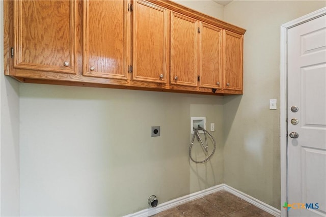 127 Ariana Ct, Killeen, TX 76542 - laundry room featuring hookup for a washing machine, cabinet space, electric dryer hookup, and dark tile patterned flooring