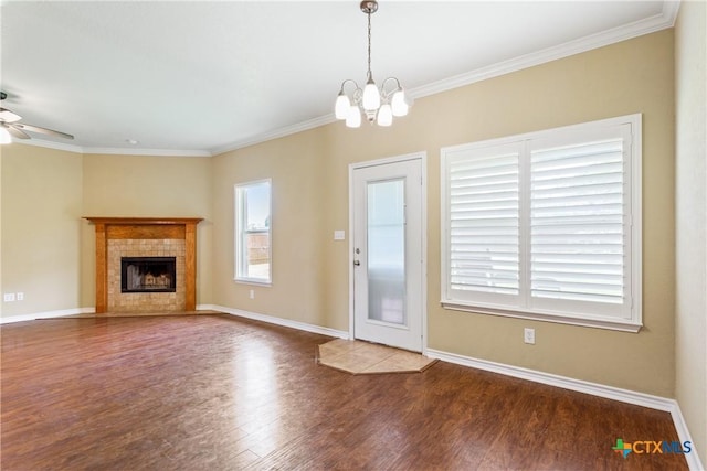 127 Ariana Ct, Killeen, TX 76542 - unfurnished living room with healthy amount of natural light, a ceiling fan, wood finished floors, a chandelier, and ornamental molding