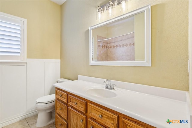 127 Ariana Ct, Killeen, TX 76542 - bathroom with vanity, tile patterned floors, a shower, and a wainscoted wall