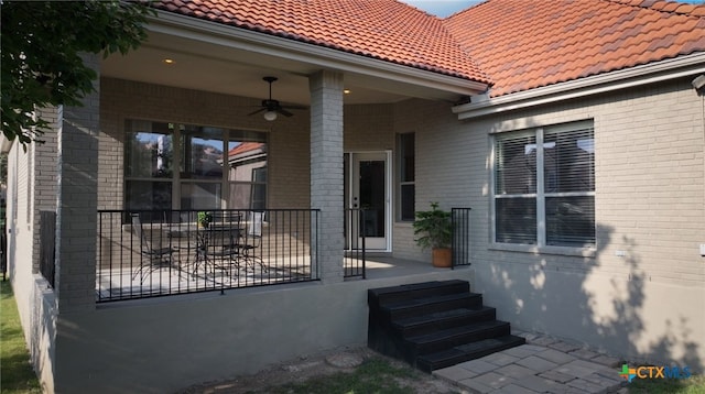 property entrance featuring covered porch and ceiling fan