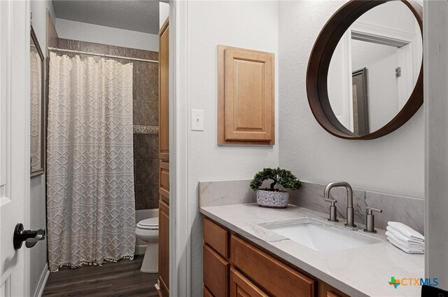 bathroom featuring vanity, a shower with curtain, toilet, a textured ceiling, and wood-type flooring