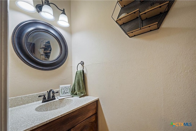 bathroom with a notable chandelier and vanity