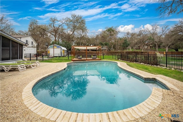 view of swimming pool featuring a fenced in pool, a patio area, a fenced backyard, and a sunroom