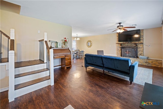 living room with stairs, a fireplace, and dark wood-style flooring