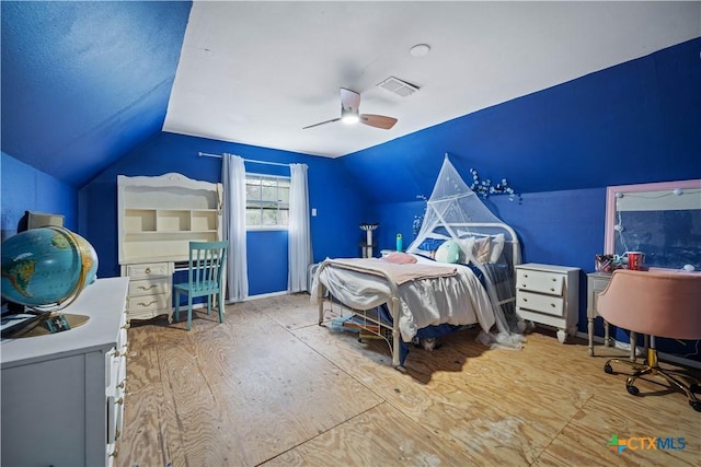 bedroom with ceiling fan, visible vents, and vaulted ceiling