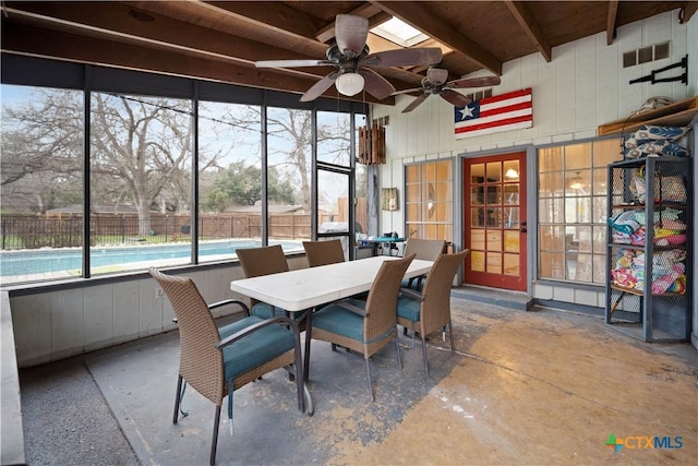 unfurnished sunroom with visible vents, ceiling fan, and beam ceiling