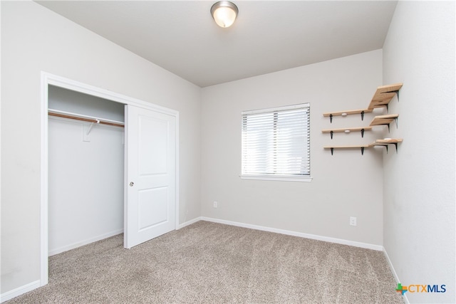 unfurnished bedroom with light carpet and a closet