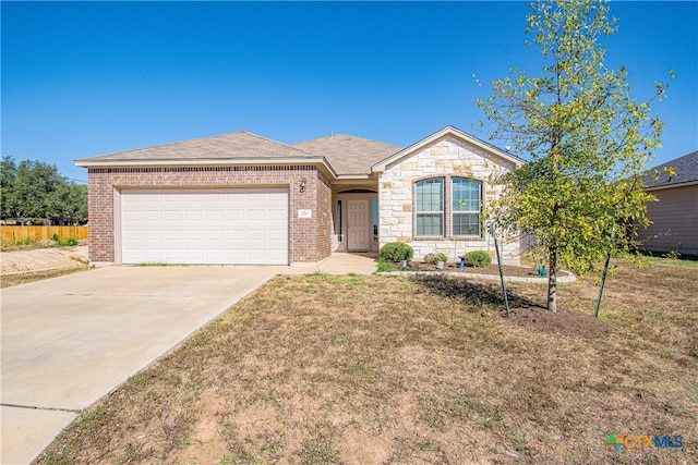 single story home featuring a garage and a front lawn