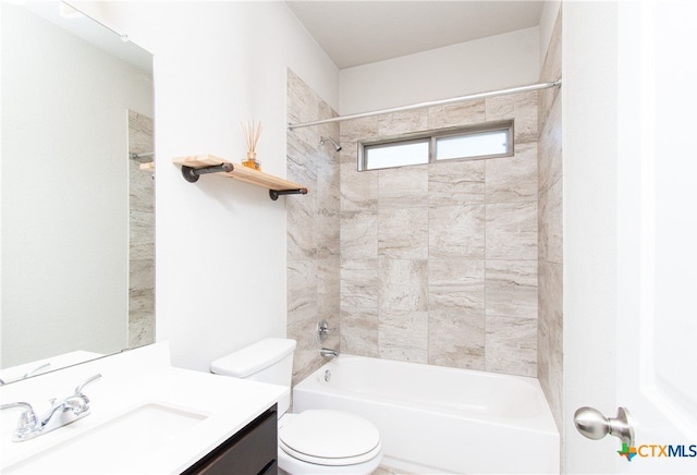 full bathroom featuring vanity, tiled shower / bath combo, and toilet