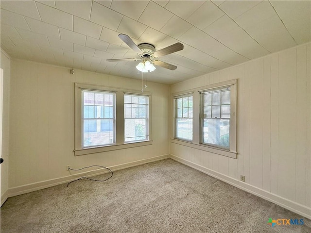1015 N 3rd St, Temple, TX 76501 - carpeted empty room with a ceiling fan and wood walls