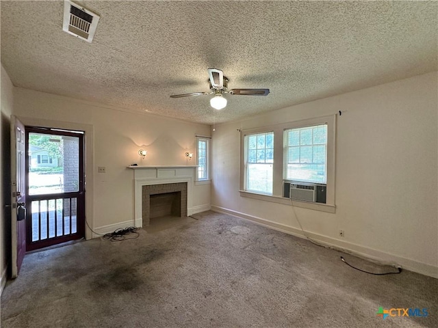 1015 N 3rd St, Temple, TX 76501 - unfurnished living room featuring carpet flooring, a ceiling fan, a fireplace, a textured ceiling, and cooling unit