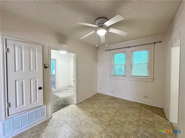 1015 N 3rd St, Temple, TX 76501 - empty room with ceiling fan and a textured ceiling