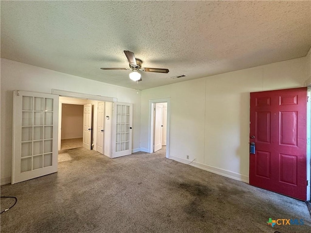 1015 N 3rd St, Temple, TX 76501 - unfurnished bedroom with french doors, carpet, a textured ceiling, and ceiling fan