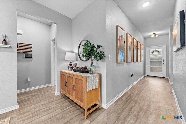 hallway with light hardwood / wood-style flooring