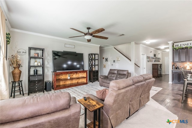 8907 Misty Pine Dr, Temple, TX 76502 - living area featuring ceiling fan, crown molding, wood finished floors, and stairway