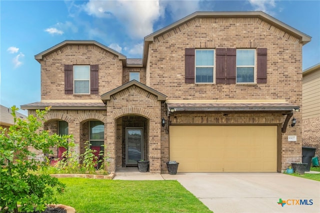 8907 Misty Pine Dr, Temple, TX 76502 - view of front of property featuring brick siding, an attached garage, concrete driveway, and a front yard