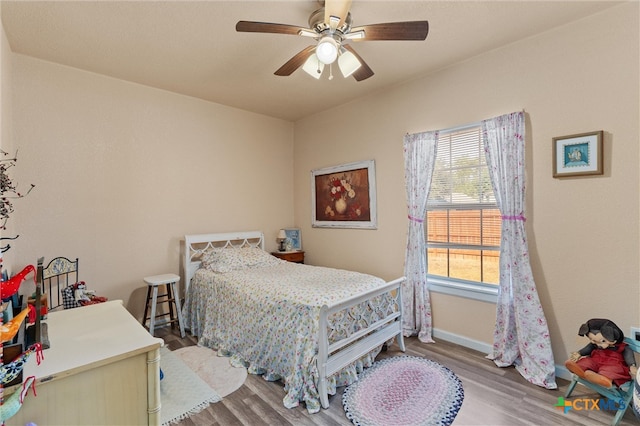 bedroom with hardwood / wood-style floors and ceiling fan