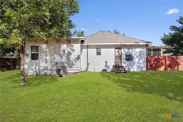 rear view of house with a yard