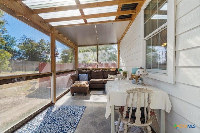 sunroom featuring a wealth of natural light and a skylight