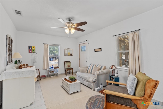 tiled living room featuring ceiling fan