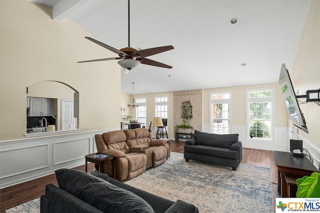 living room with high vaulted ceiling, hardwood / wood-style floors, ceiling fan, and beam ceiling