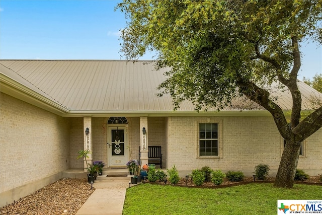 view of front of home with a front yard and a porch