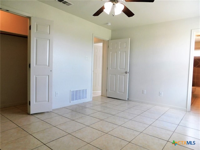 unfurnished bedroom featuring light tile patterned floors and ceiling fan