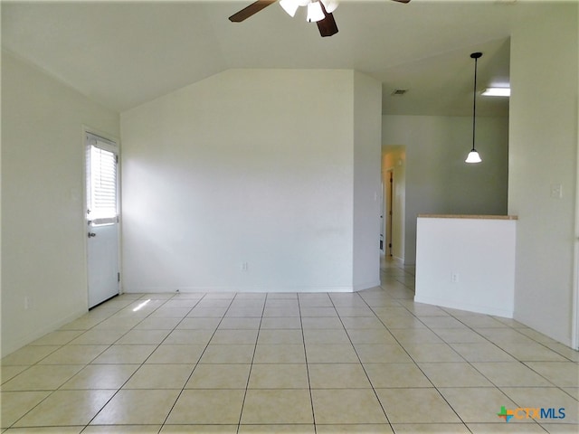 tiled empty room with lofted ceiling and ceiling fan