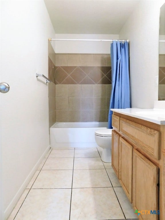 full bathroom featuring vanity, tile patterned floors, toilet, and shower / bath combination with curtain